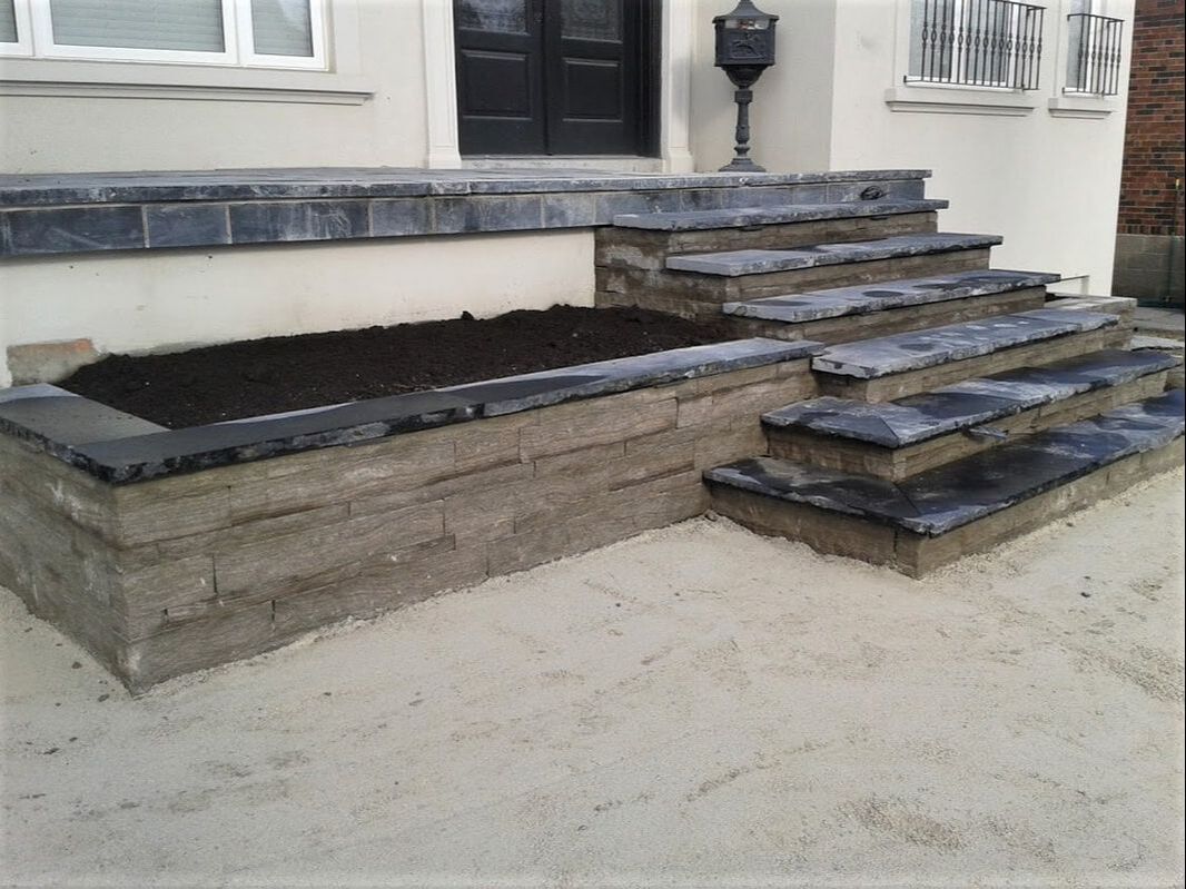 Landscape construction of front stairs and planter from natural stone in Toronto